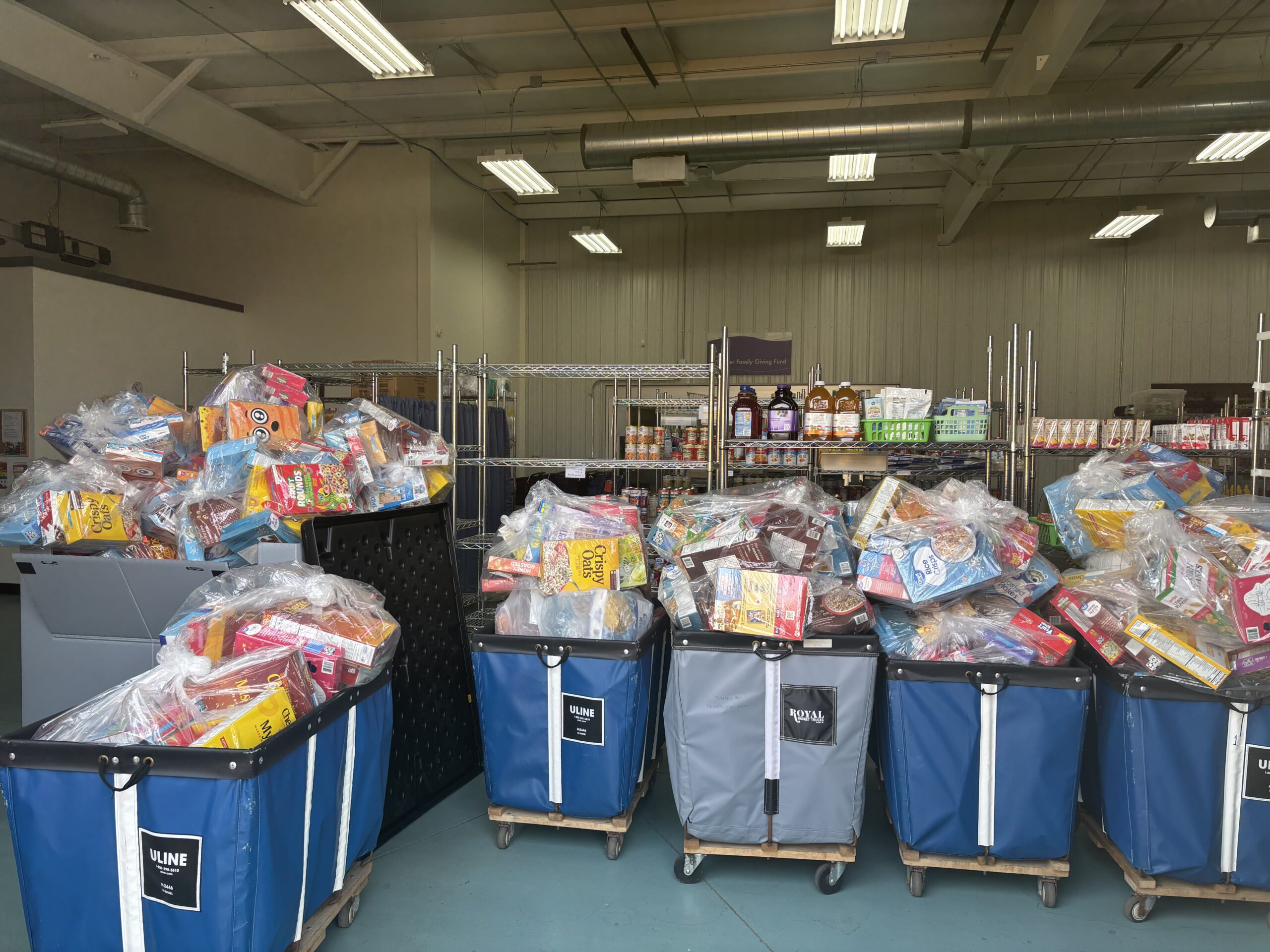 Carts of cereal boxes are lined up in the SASS food pantry warehouse