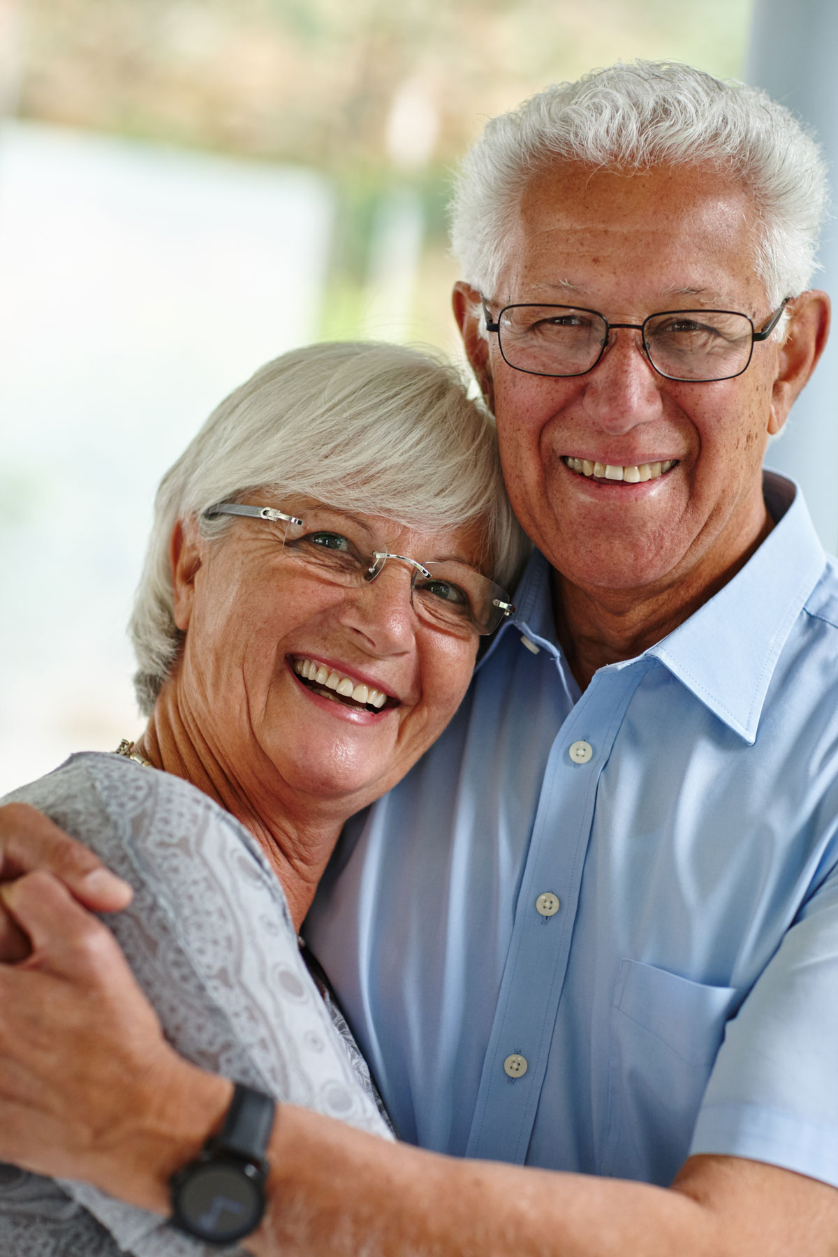 Senior couple hugging and considering planned giving